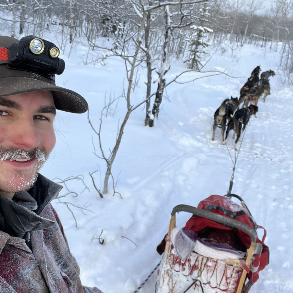 Liam selfie while he's dog sledding